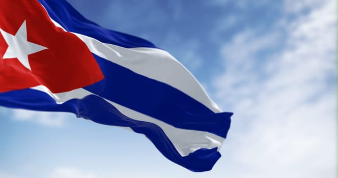 Cuba national flag waving in the wind on a clear day. Five blue and white stripes, a red triangle at the hoist with a white star. 3d illustration render. Selective focus