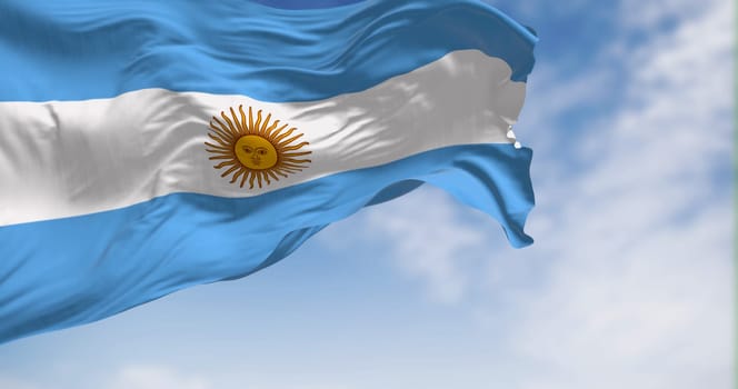 Argentina national flag fluttering in the wind on a sunny day. Three equal blue and white horizontal bands with the Sun of May in the center. 3d illustration render. Selective focus