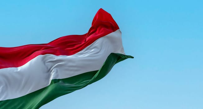 The national flag of Hungary fluttering in the wind on a clear day. Horizontal striped flag of red, white and green. 3d illustration render. Fluttering fabric