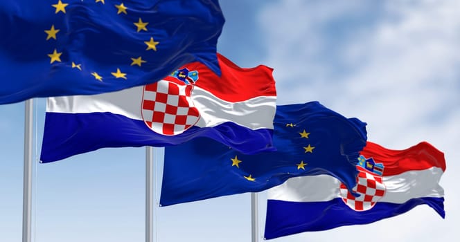 The flags of Croatia and the European Union fluttering together on a clear day. Croatia has been a member of the eurozone since January 1, 2023. 3D illustration render. Fluttering fabric