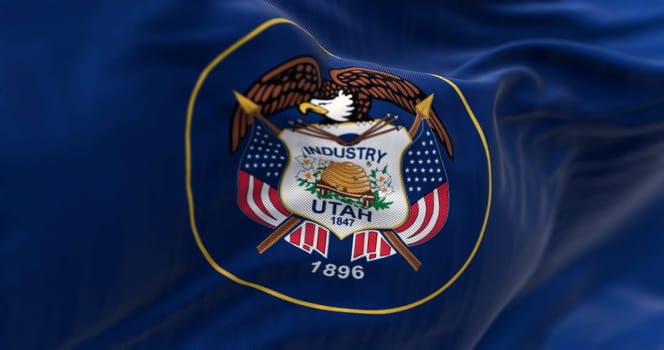 Utah state flag fluttering in the wind. State seal surrounded by a golden circle on a dark blue background. 3D illustration render. Close-up. Fluttering fabric background