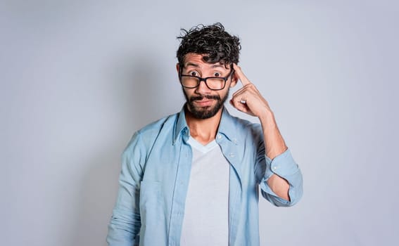 Person thinking with his finger on his head isolated, Thoughtful man with his finger on his head with copy space