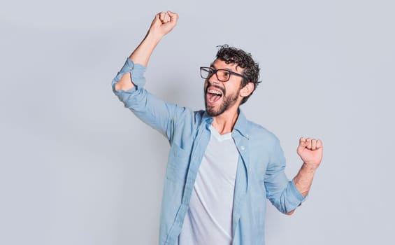 Handsome man raising his hand in victory isolated, Person celebrating and raising his hand in victory, Concept of person clenching and raising one hand in victory