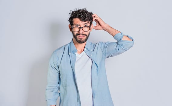 Confused person scratching his head on isolated background, Handsome man scratching his head with confused face isolated