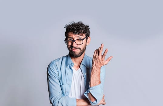 Puzzled man gesturing with one hand, Person with puzzled face frowning, Close up of puzzled people gesturing with hands.