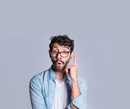 Amazed person pointing an advertisement up, Amazed people pointing with a hand up, Surprised man pointing up with a new idea
