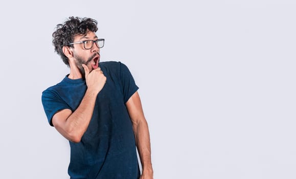 Amazed person with open mouth looking to the side, astonished handsome man looking at an advertisement. astonished people looking at a banner to the right