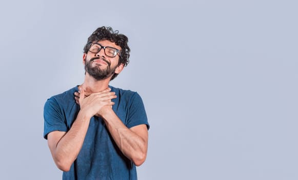 Relaxed person with thanks gesture with hands on chest. Grateful people smiling with hands on chest. Positive looking friendly handsome man with charming sincere smile feeling thankful