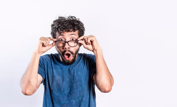 Surprised handsome man taking off his glasses, Person taking off his glasses surprised by a promotion, man opening his mouth surprised taking off his glasses