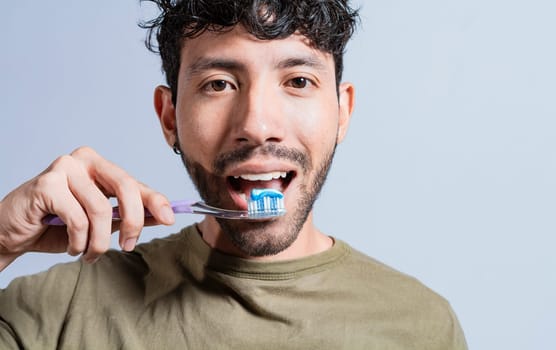 Close up of man brushing his teeth isolated, Face of handsome man brushing his teeth. Tooth brushing and care concept. Face of guy brushing teeth isolated. Oral and dental smile concept