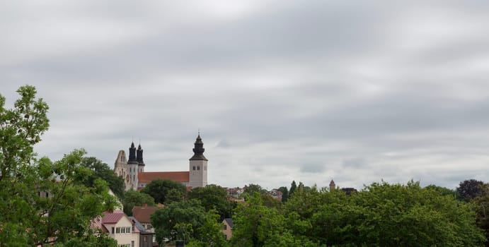 The Visby Church on Gotland in Sweden with a cloudy sky and trees.