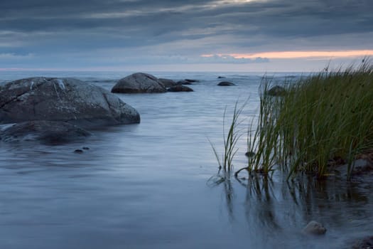 Calm Ocean with Rocks and Sea Weed.