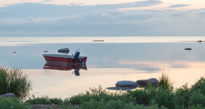 Motor Boat on Calm Sea with clouds in the skies.