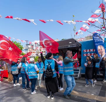 Istanbul, Turkey - May 13 2023: Supporters of Kemal Kilicdaroglu dancing while holding the Turkish flags in front of Republican Peoples Party kiosk in Uskudar neighbourhood during 2023 elections