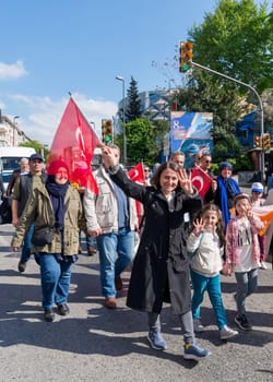 Istanbul, Turkey - May 13 2023: Woman and her children making four fingered sign during march of AK Party in Cumhuriyet street, Uskudar neighbourhood during 2023 elections