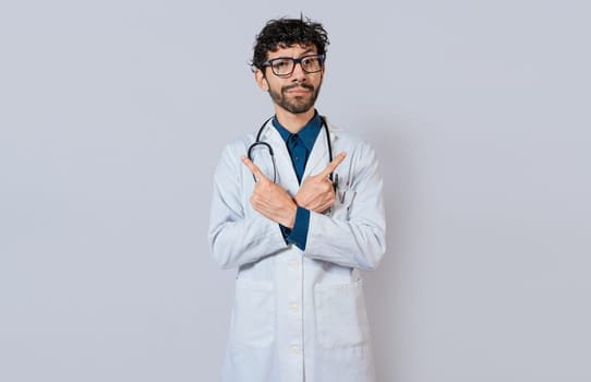 Doctor pointing to both sides isolated. Bearded doctor pointing to both sides on isolated background. Doctor pointing at an advertising space with both hands