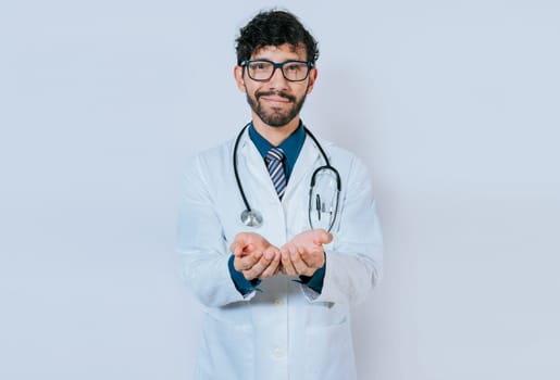 Doctor with hands together and empty. Hands of young doctor presenting something empty-handed. Doctor holding something in his hands isolated