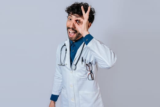Handsome doctor approving and recommending isolated. Happy doctor gesturing approval isolated, Latin doctor approving on isolated background