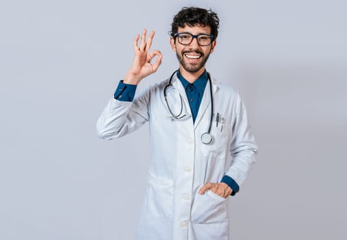 Happy doctor gesturing approval isolated. Handsome doctor approving and recommending isolated