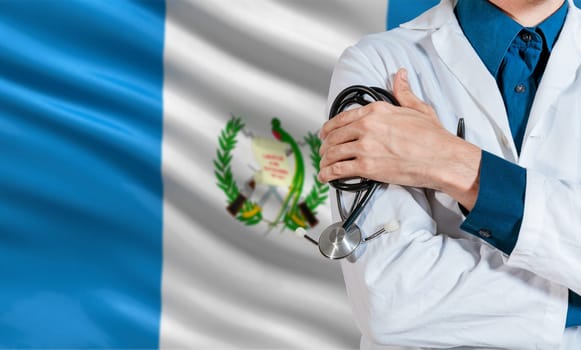 Doctor with stethoscope on guatemala flag. Health and care with the flag of Guatemala. Guatemala national health concept, Doctor arm with stethoscope on Guatemala flag