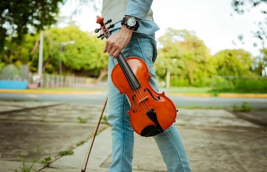 Close up of hands holding violin and hoop. Hands holding violin and hoop outdoors, Concept of person holding violin and hoop outdoors