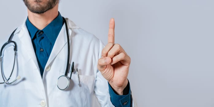 Doctor finger pointing up with text space. Unrecognizable doctor pointing up, Hand of doctor pointing up