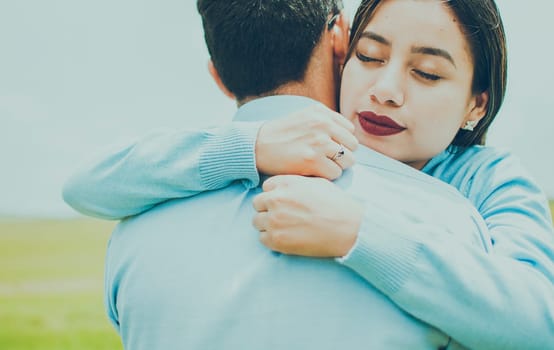 Close up of a girl giving a loving hug, Concept of a couple lovingly embracing each other in the field, close up of a girl giving a hug of love and comfort