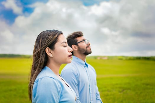 Two people breathing fresh air in the field, Young couple breathing fresh air in the field, Concept of Young couple breathing fresh air with positive attitude