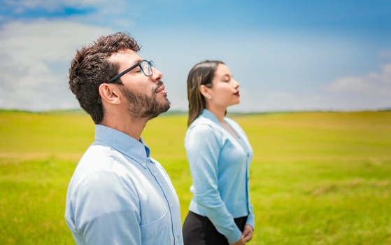 Concept of Young couple breathing fresh air with positive attitude, Two people breathing fresh air in the field, Young couple breathing fresh air in the field
