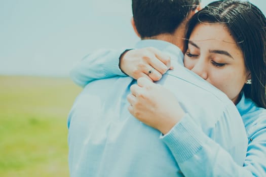 Concept of a couple lovingly embracing each other in the field, Close up of a girl giving a loving hug, close up of a girl giving a hug of love and comfort