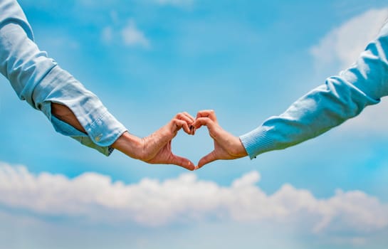 Hands of a couple in love in the field making a heart shape, couple in the field making a heart shape with hands, Close up of hands of a couple making a heart shape with hands