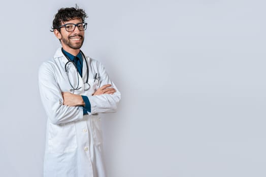 Smiling doctor with crossed arms on isolated background. Latin doctor with crossed arms on isolated background, Portrait of young doctor with arms crossed