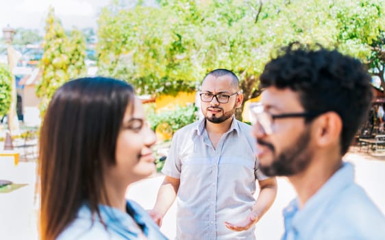 Man discovering his cheating girlfriend with another man outdoor, Boyfriend discovering his girlfriend's infidelity outdoors. Man looking at his cheating girlfriend with another man outdoors