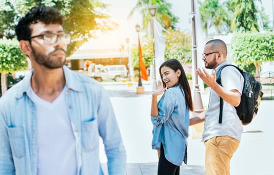 Distracted girlfriend looking at another man on the street. Unfaithful girlfriend looking at another man on the street, Unfaithful girl looking at another man on street and her boyfriend claims her
