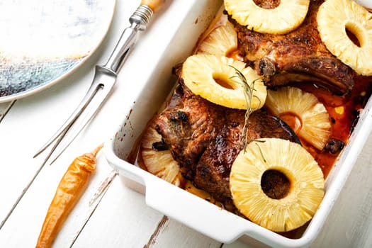 Meat steak fried with pineapple rings. Barbecue in baking tray. Grilled pork chop with pineapple