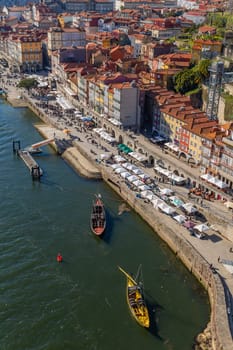 Porto, Portugal - March 02, 2023: View of Ribeira historical quarter on the margin Douro river embankment in the old town and Luis I bridge, Porto, Portugal.