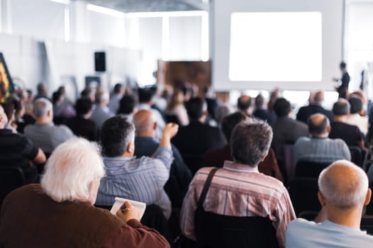 Speaker Giving a Talk at Business Meeting. Audience in the conference hall. Business and Entrepreneurship.