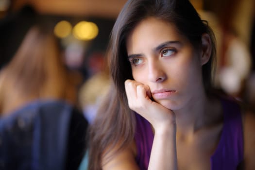 Bored woman waiting in a restaurant interior