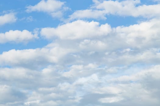 Beautiful blue sky background with tiny white clouds. Real photography
