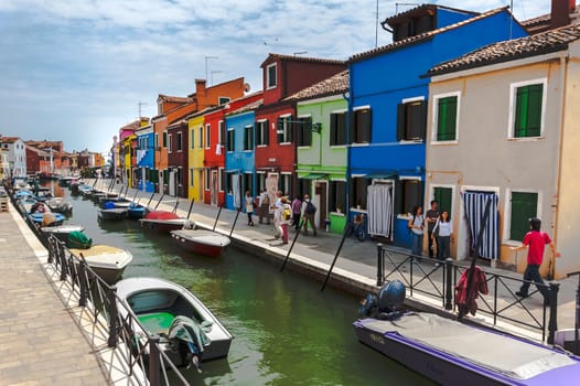 Venice, Italy - 06/09/2009 - Tourists visiting Burano. The island of the Venetian lagoon famous for its brightly colored houses