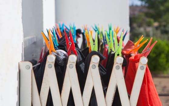 Full-loaded heavy Duty Wall-Mounted Drying Rack at apartment block. Selective focus on pegs