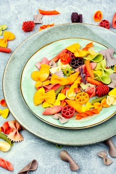 Colorful italian raw pasta or macaroni for kids.