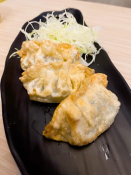 Japanese Pan-fried gyoza dumpling with soy sauce, stock photo