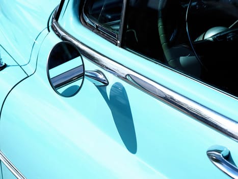 Sideview mirror of an old vintage car, conceptual vintage background with space for text