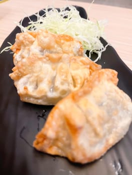 Japanese Pan-fried gyoza dumpling with soy sauce, stock photo