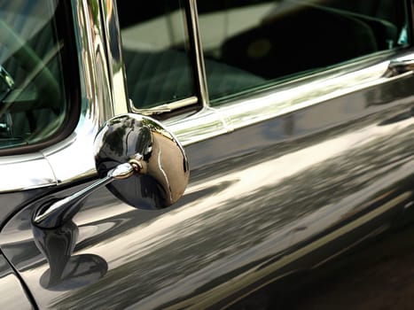 Sideview mirror of an old vintage car, conceptual vintage background with space for text