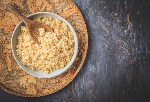 Freshly cooked bulgur in bowl. Bulgur wheat grains.