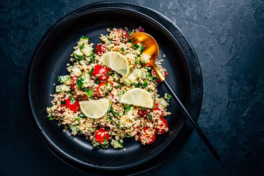 Tabbouleh salad, traditional middle eastern and arab dish. Levantine vegetarian salad with parsley, mint, bulgur, tomato and cucumber