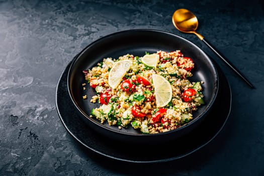 Tabbouleh salad, traditional middle eastern and arab dish. Levantine vegetarian salad with parsley, mint, bulgur, tomato and cucumber