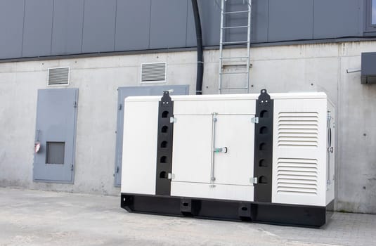 Emergency, backup industrial generator for uninterruptible power supply, diesel installation in a white iron case. Emergency power supply